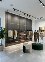 Modern clothing store interior with mannequins and shelves.