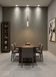 Modern dining room with wooden table and gray chairs against a gray wall.