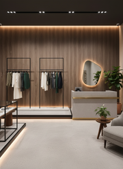 Modern clothing store interior with wooden walls, clothing racks, and a reception desk.
