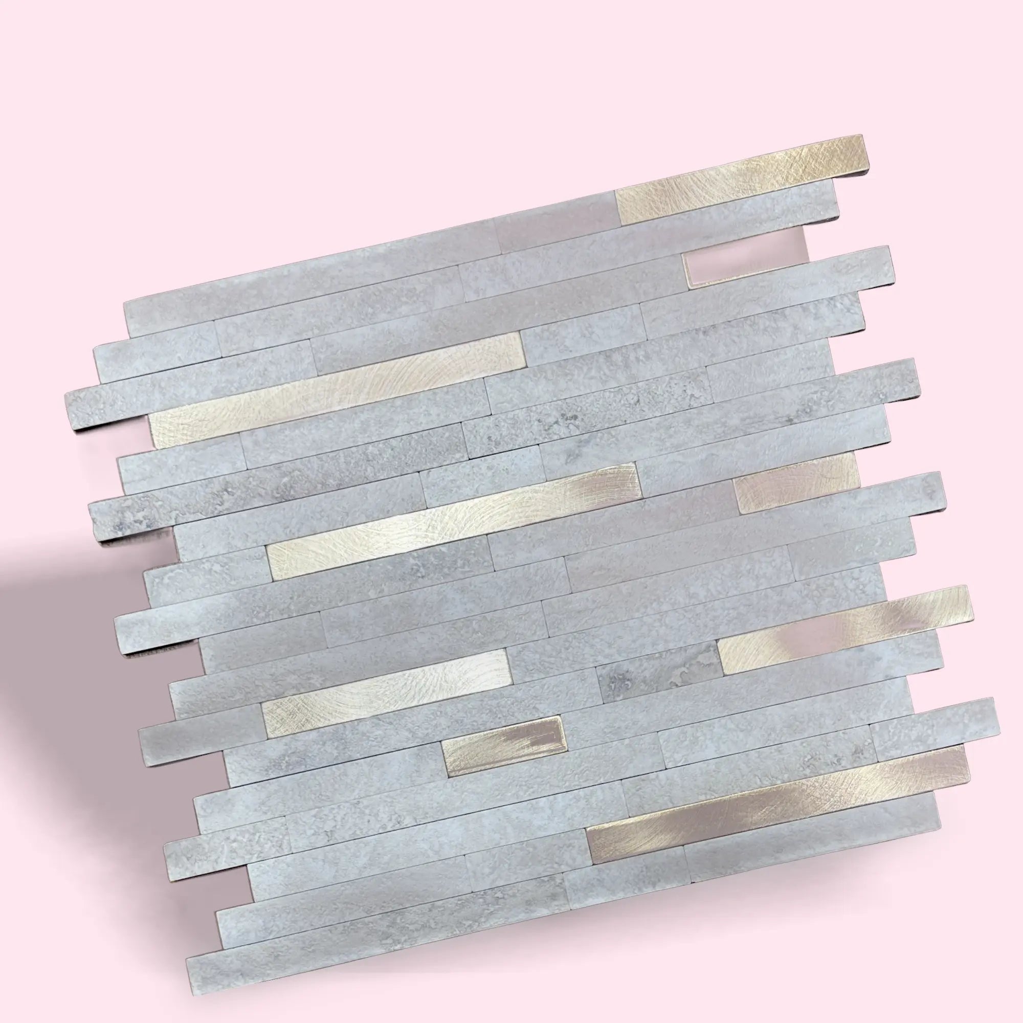 Gold peel stick mosaic tile from LuxWorld, showing a close-up of the textured, shiny mosaic pattern on a white background.