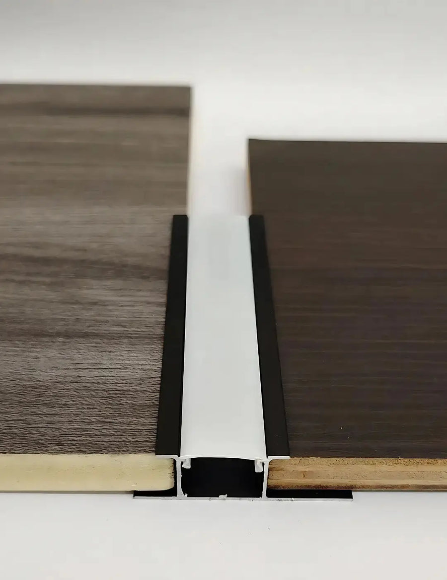 Black aluminum profile wall cladding for LED strip lights by LUXWORLD, designed for sleek, professional lighting installations.