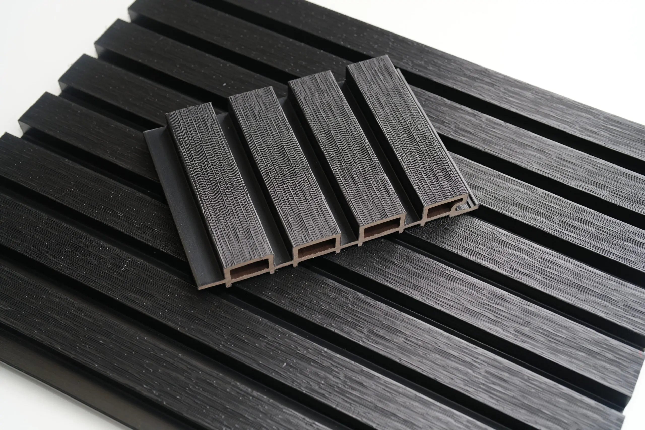 Black outdoor wall panel from LUXWORLD, modern WPC exterior cladding for outdoor wall decoration and protection.