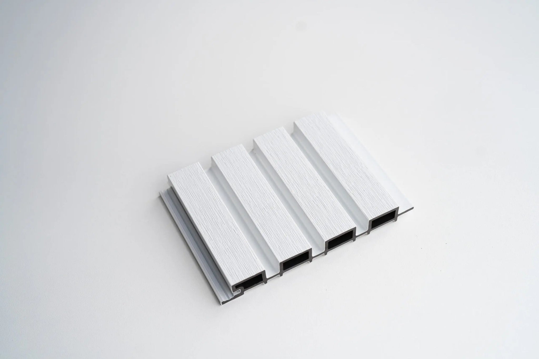 White WPC outdoor wall cladding panel by LUXWORLD, weatherproof exterior wall covering for durable, stylish exterior cladding.