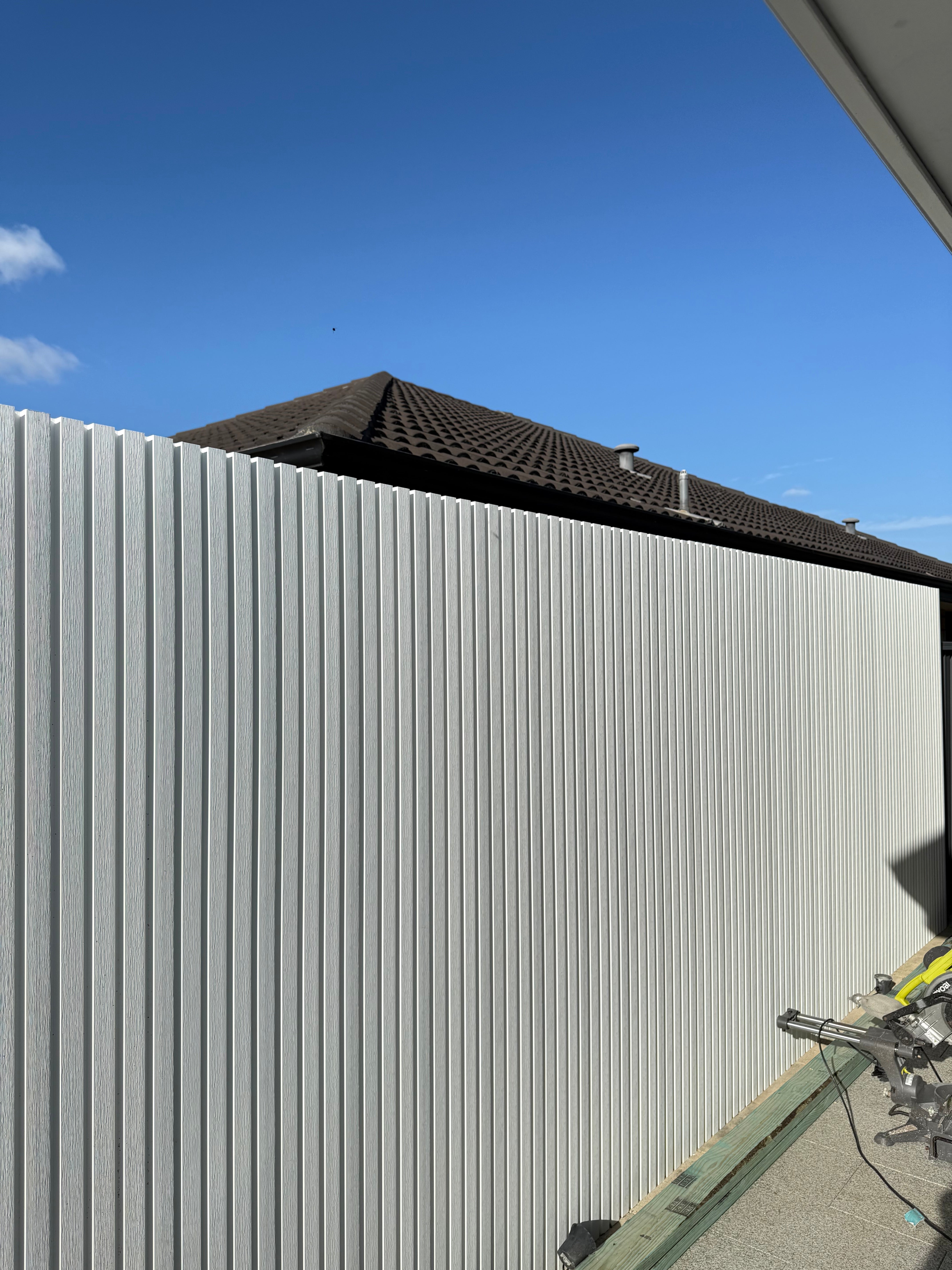 White WPC outdoor wall cladding panel by LUXWORLD, weatherproof exterior wall cladding for outdoor building facades.