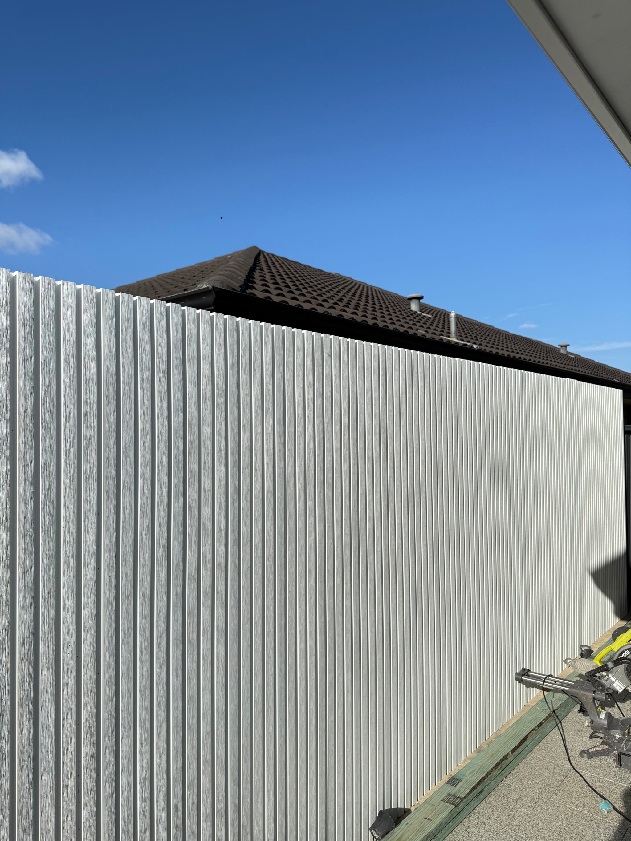 White WPC outdoor wall cladding panel by LUXWORLD, weatherproof exterior wall cladding for outdoor building facades.